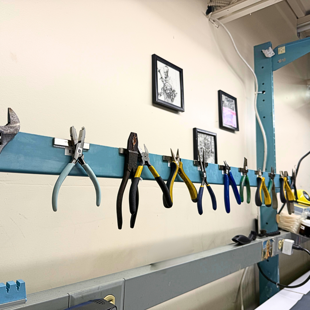 Service Station with Tools against a wall, with 3 picture frames in the background