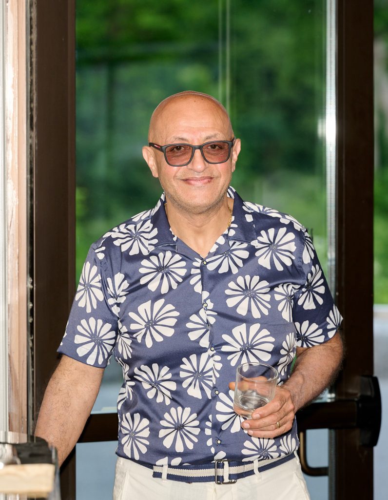 An image of the founder standing alone with a glass in hand. Founder of Endoch Inc. (Endoch Medical).